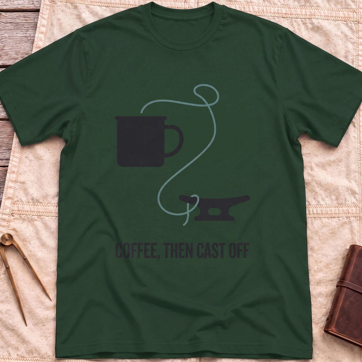 Front view of the forest green Coffee Then Cast Off T-Shirt with a mug and a single line trailing from it to a dock cleat.