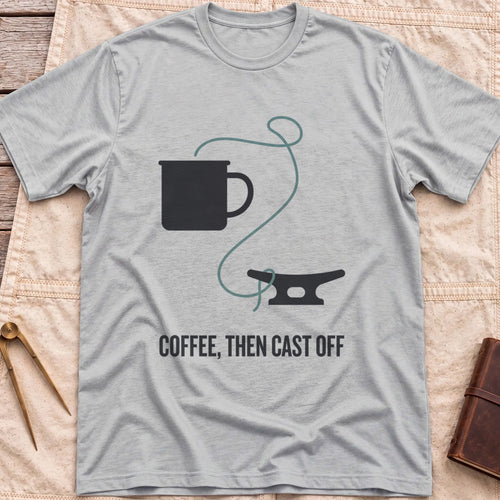 Front view of the sport grey Coffee Then Cast Off T-Shirt with a mug and a single line trailing from it to a dock cleat.