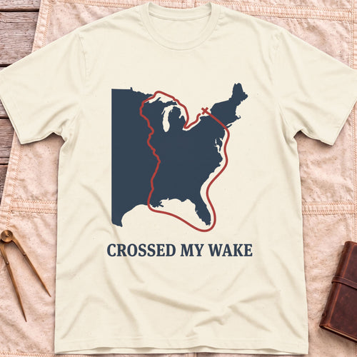 Front view of the natural Crossed My Wake T-Shirt with a red route line looping around a map of the eastern United States.