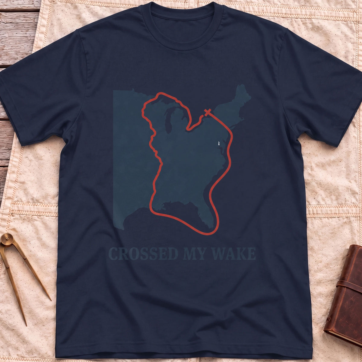 Front view of the navy Crossed My Wake T-Shirt with a red route line looping around a map of the eastern United States.