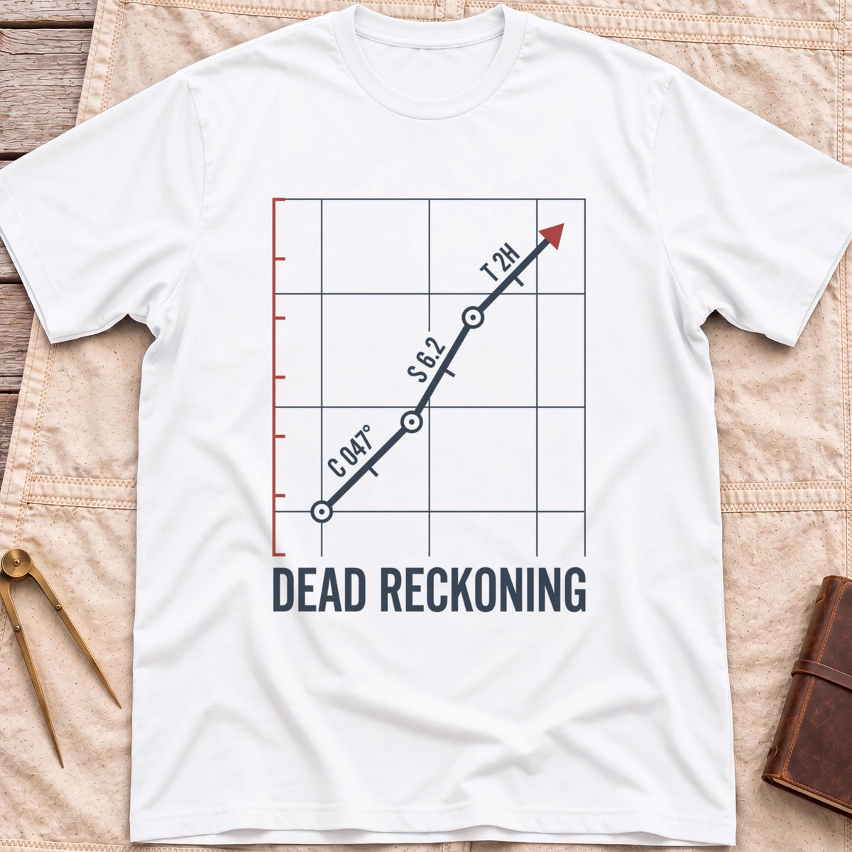 Front view of the white Dead Reckoning T-Shirt with a gridded plot showing a course line marked C 047°, S 6.2 and T 2H ending in a red arrow.