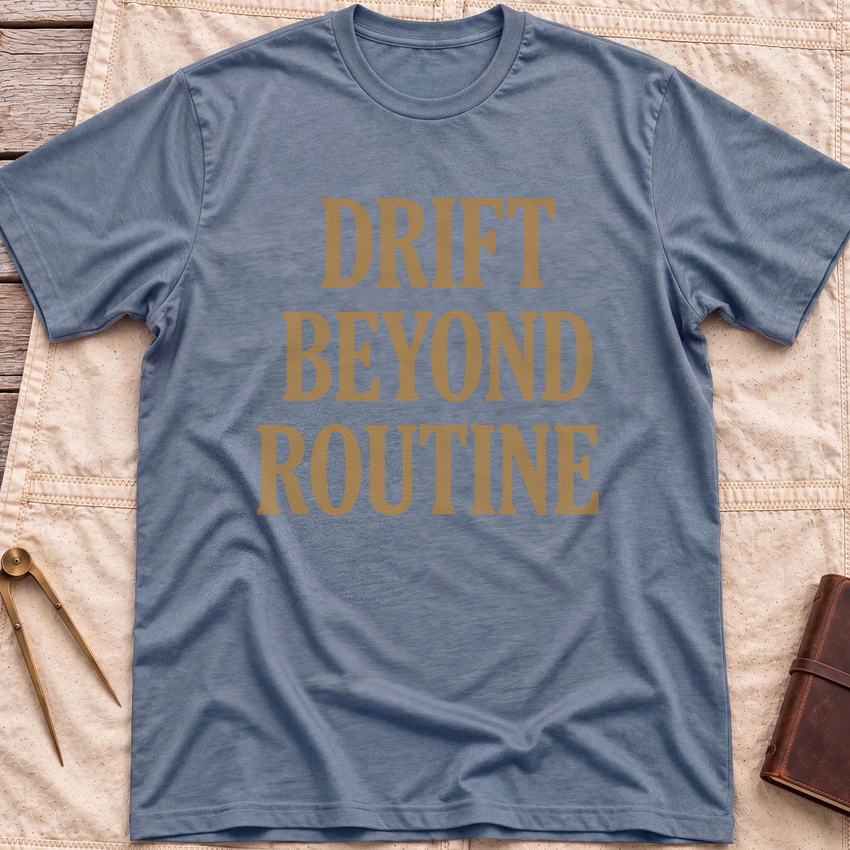 Front view of the heather indigo Drift Beyond Routine T-Shirt with the words Drift Beyond Routine in large tan capitals.
