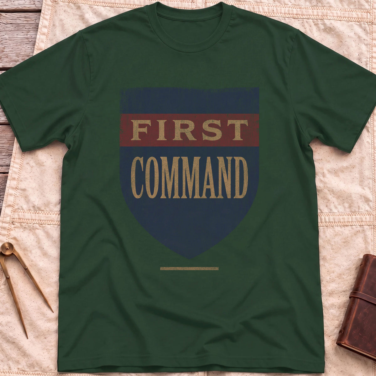 Front view of the forest green First Command T-Shirt with a distressed navy shield and a red band, lettered First Command.