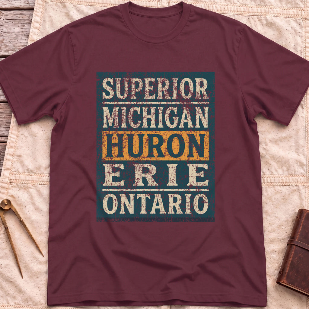 Front view of the maroon Five Lakes T-Shirt with a distressed panel listing Superior, Michigan, Huron, Erie and Ontario, with Huron highlighted.