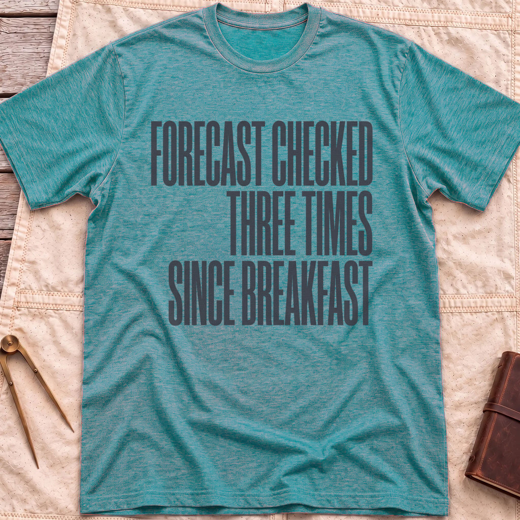 Front view of the heather galapagos blue Forecast Again T-Shirt with the words Forecast Checked Three Times Since Breakfast in tall condensed capitals.