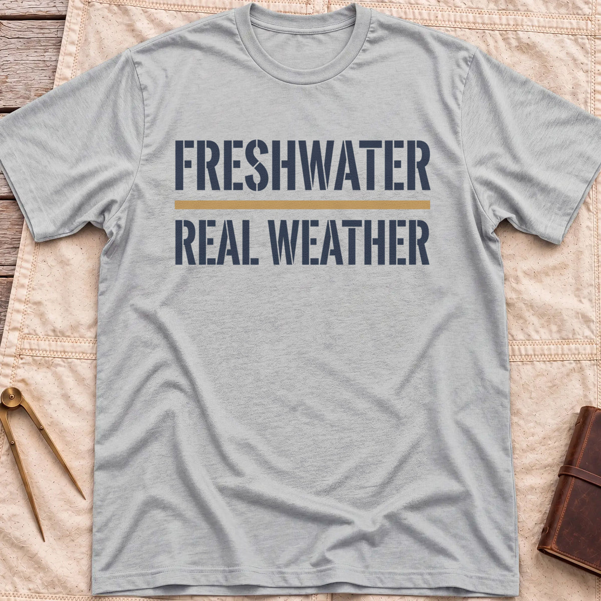 Front view of the sport grey Freshwater Real Weather T-Shirt with the words Freshwater and Real Weather in bold capitals, split by a tan line.