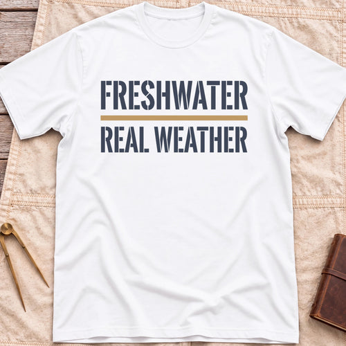 Front view of the white Freshwater Real Weather T-Shirt with the words Freshwater and Real Weather in bold capitals, split by a tan line.