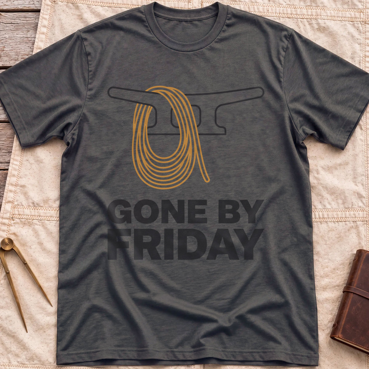 Front view of the dark heather Gone by Friday T-Shirt with a coiled rope looped over a dock cleat.