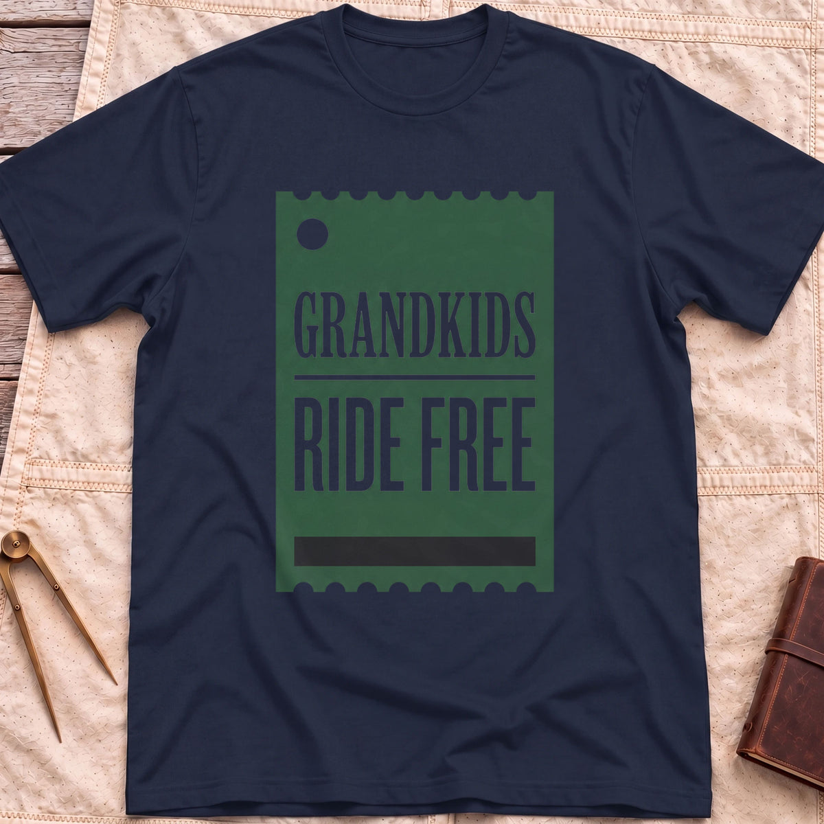 Front view of the navy Grandkids Ride Free T-Shirt with a green ticket-shaped graphic reading Grandkids Ride Free.