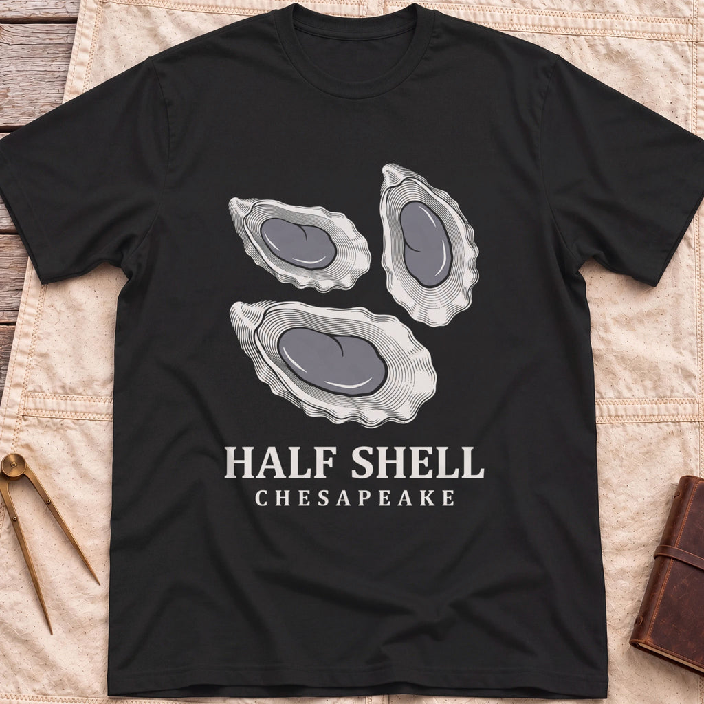 Front view of the black Half Shell T-Shirt with three detailed oyster shells above the words Half Shell, Chesapeake.