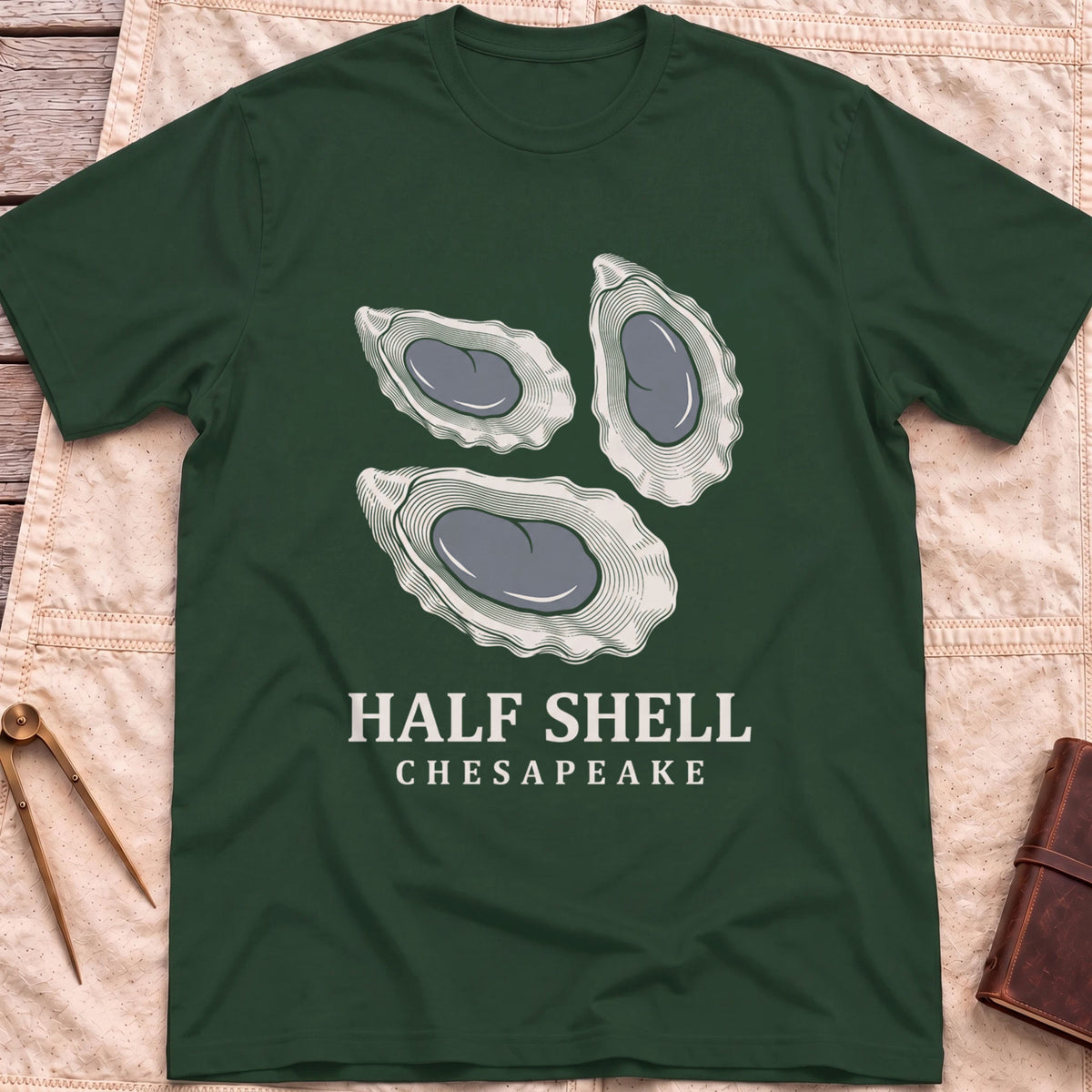 Front view of the forest green Half Shell T-Shirt with three detailed oyster shells above the words Half Shell, Chesapeake.