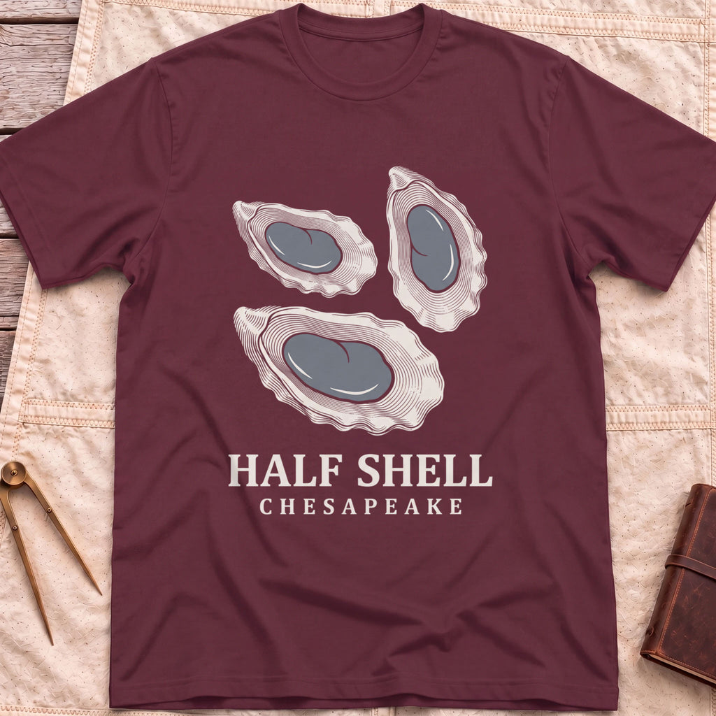 Front view of the maroon Half Shell T-Shirt with three detailed oyster shells above the words Half Shell, Chesapeake.