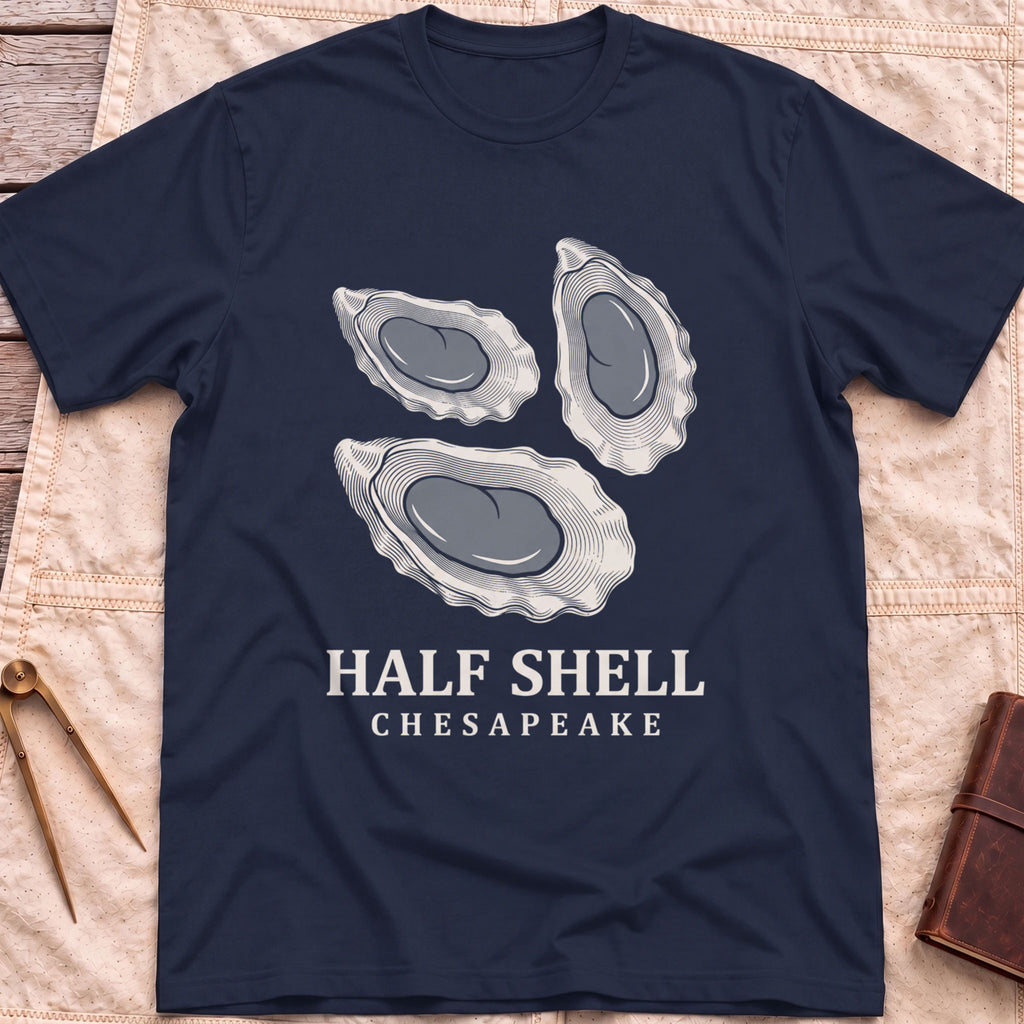 Front view of the navy Half Shell T-Shirt with three detailed oyster shells above the words Half Shell, Chesapeake.
