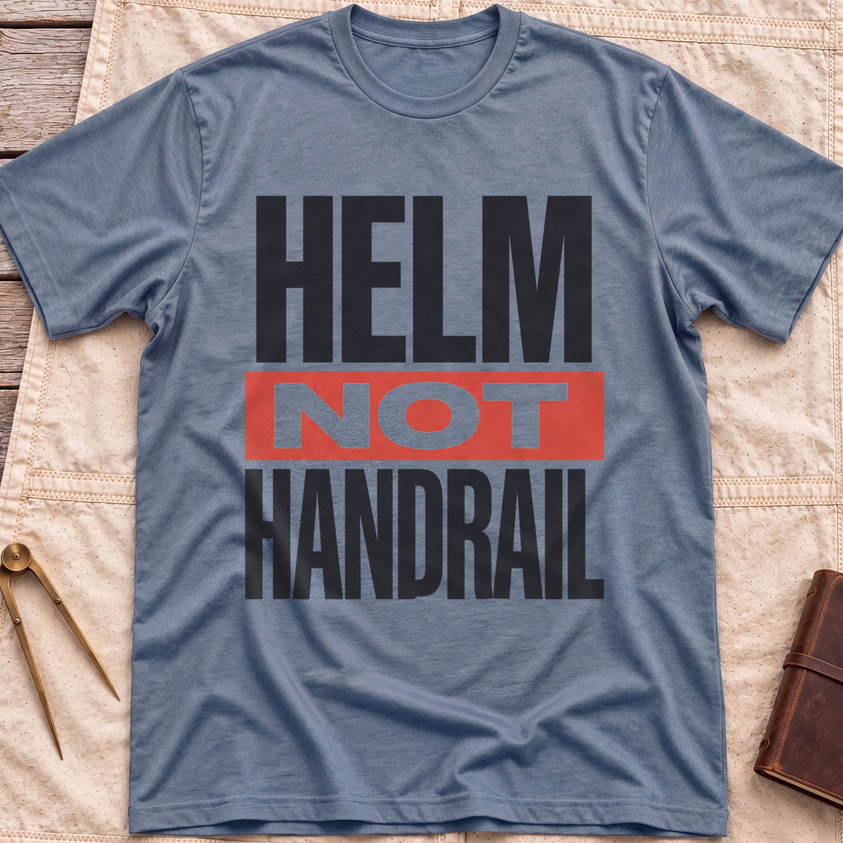 Front view of the heather indigo Helm Not Handrail T-Shirt with the words Helm Not Handrail in heavy capitals, Not set on a red bar.