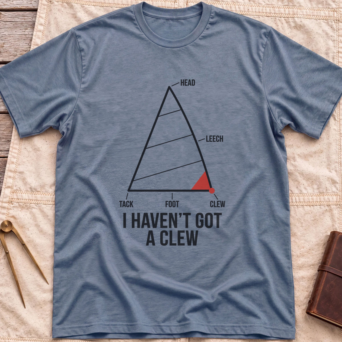 Front view of the heather indigo I Haven't Got A Clew T-Shirt with a labelled sail diagram, the clew corner marked in red.
