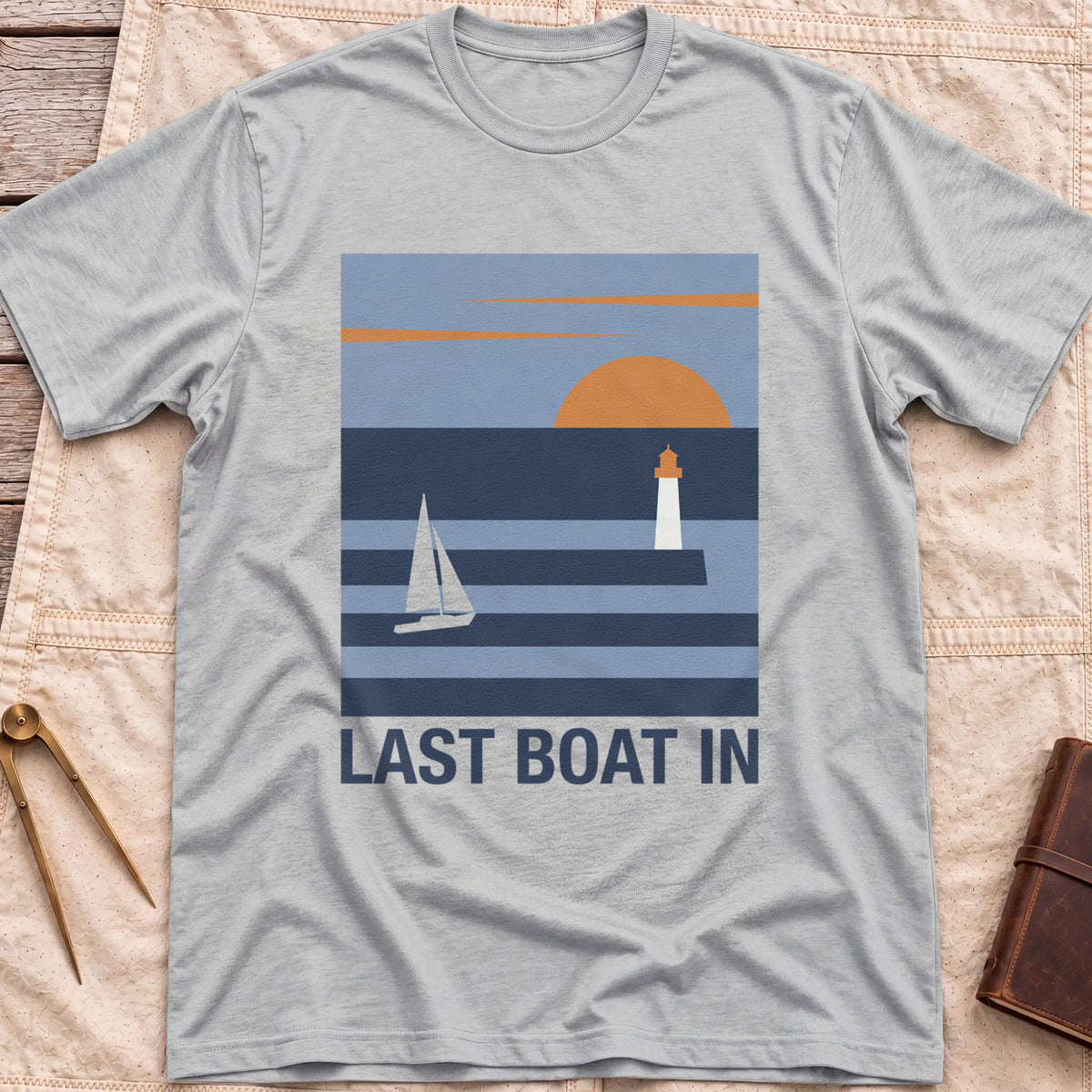 Front view of the sport grey Last Boat In T-Shirt with a square scene of a sailboat, a lighthouse and an orange sun over striped water.