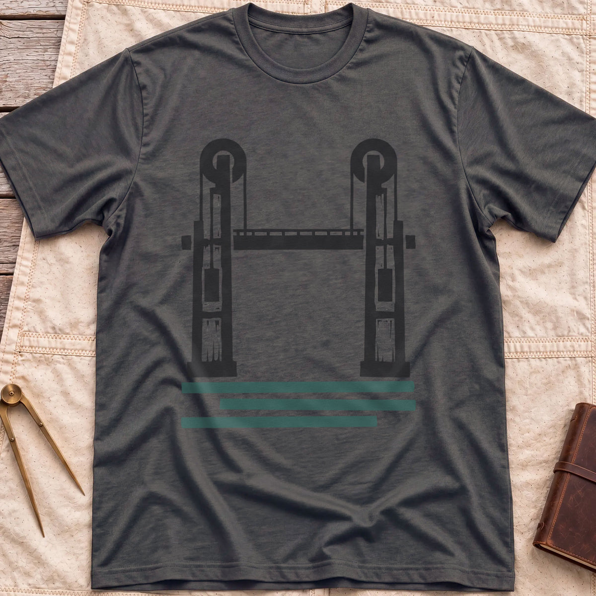 Front view of the dark heather Lift Bridge T-Shirt with a silhouette of a lift bridge, its two towers topped with wheels.