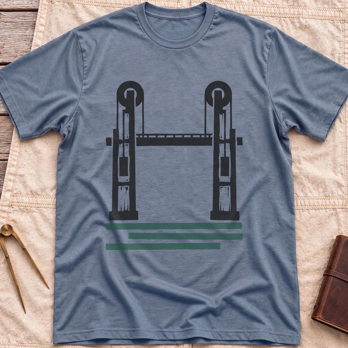 Front view of the heather indigo Lift Bridge T-Shirt with a silhouette of a lift bridge, its two towers topped with wheels.