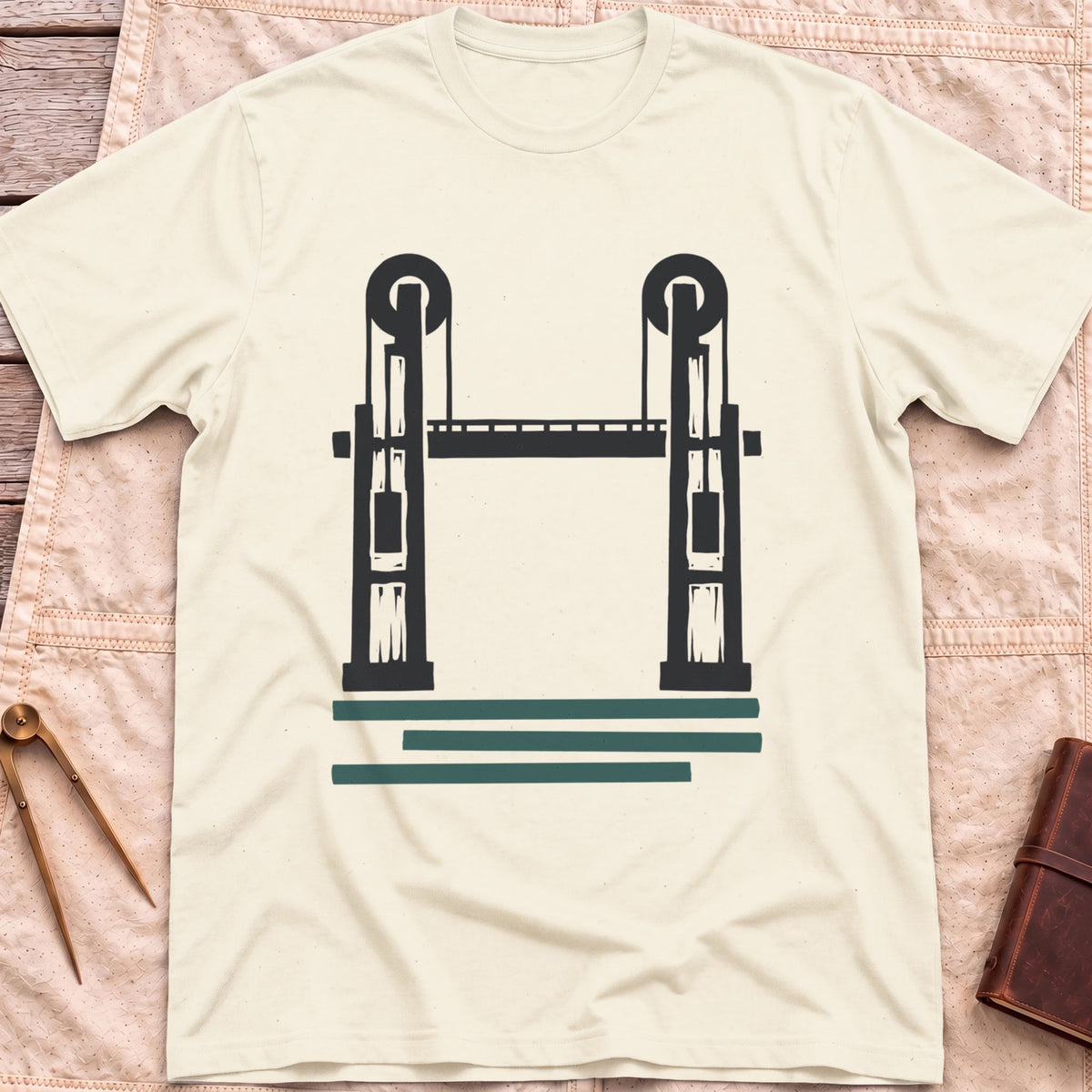 Front view of the natural Lift Bridge T-Shirt with a silhouette of a lift bridge, its two towers topped with wheels.