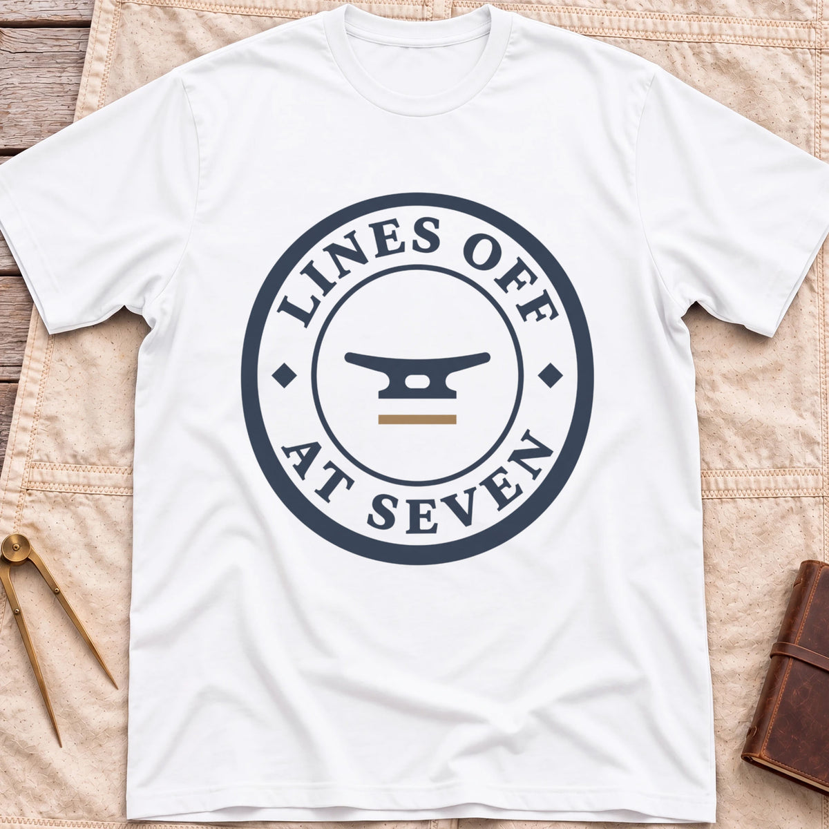 Front view of the white Lines Off at Seven T-Shirt with a round badge showing a dock cleat, ringed by the words Lines Off at Seven.