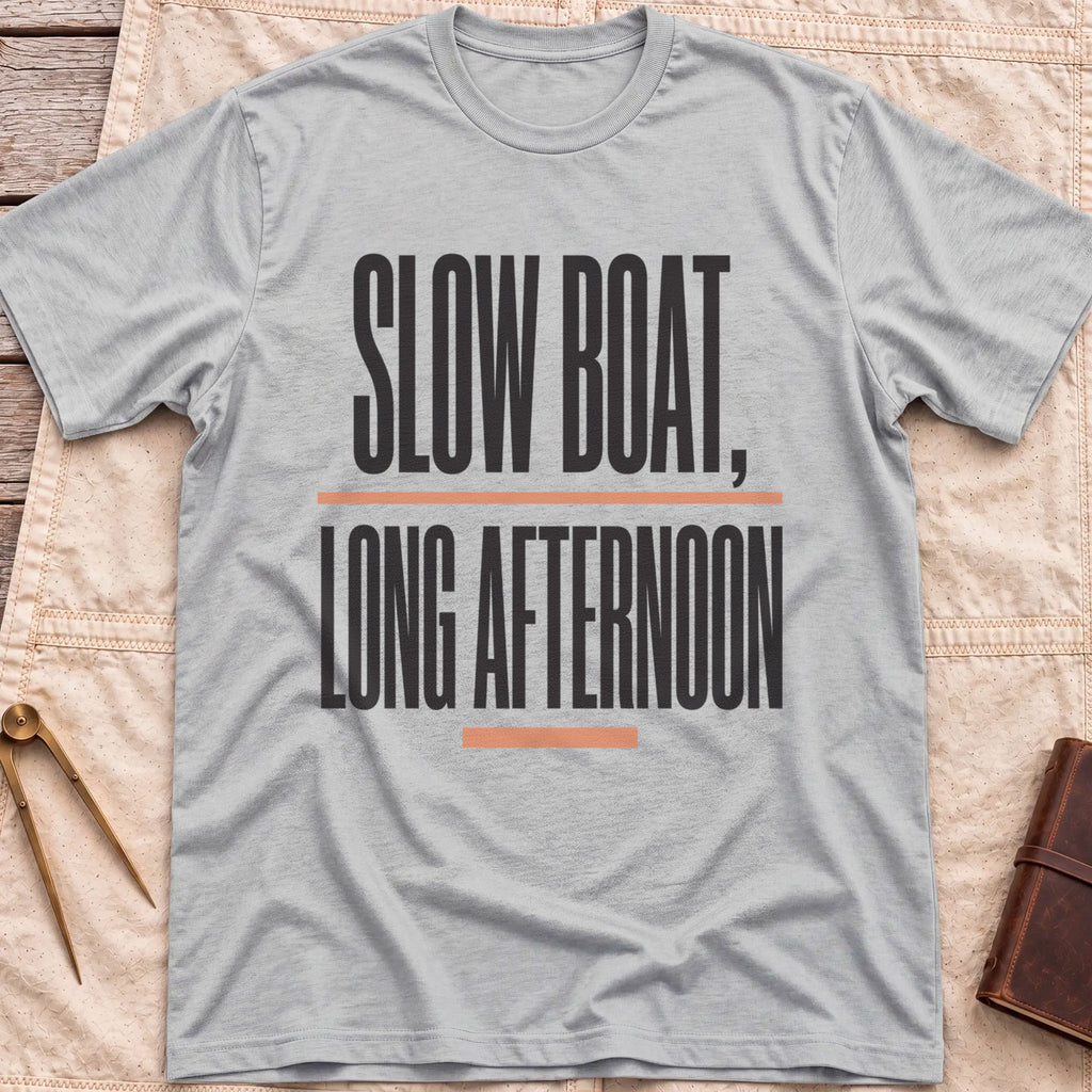 Front view of the sport grey Long Afternoon T-Shirt with the words Slow Boat, Long Afternoon in tall condensed capitals between coral rules.