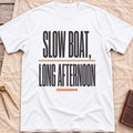 Front view of the white Long Afternoon T-Shirt with the words Slow Boat, Long Afternoon in tall condensed capitals between coral rules.