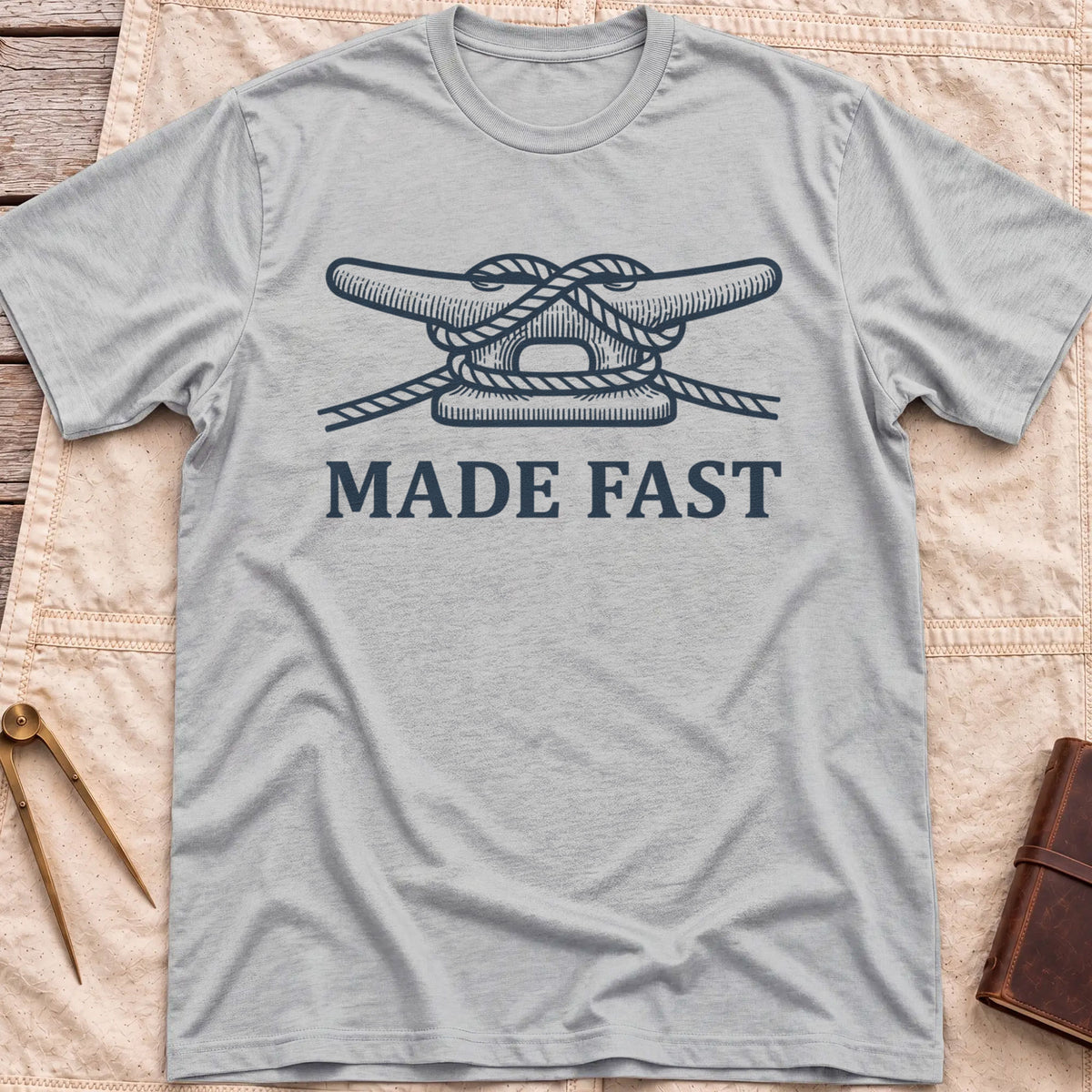 Front view of the sport grey Made Fast T-Shirt with a rope tied off around a dock cleat.