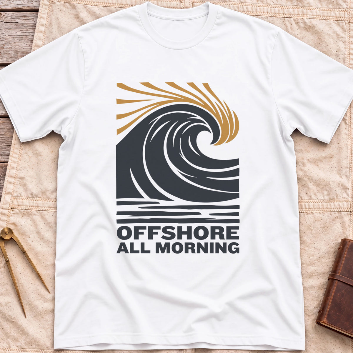 Front view of the white Offshore All Morning T-Shirt with a curling wave and tan spray lines above striped water and the words Offshore All Morning.