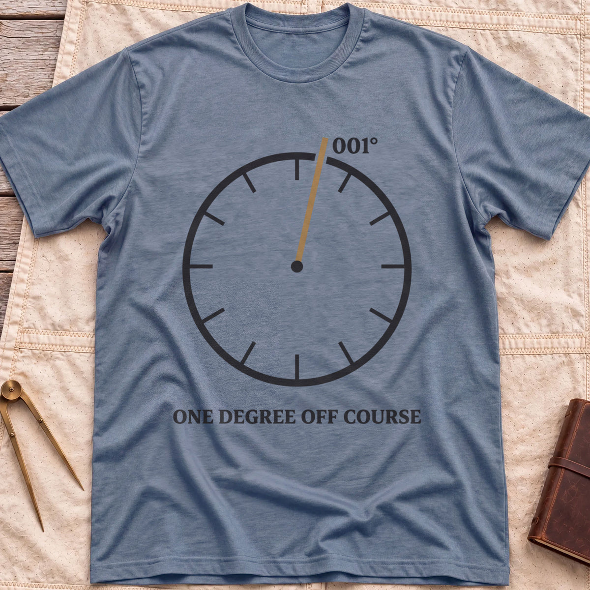 Front view of the heather indigo One Degree Off Course T-Shirt with a round dial and a tan needle pointing to 001°.