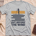 Front view of the sport grey Out Before the Wind T-Shirt with a paddleboarder silhouetted against a tan band above striped water and the words Out Before the Wind.