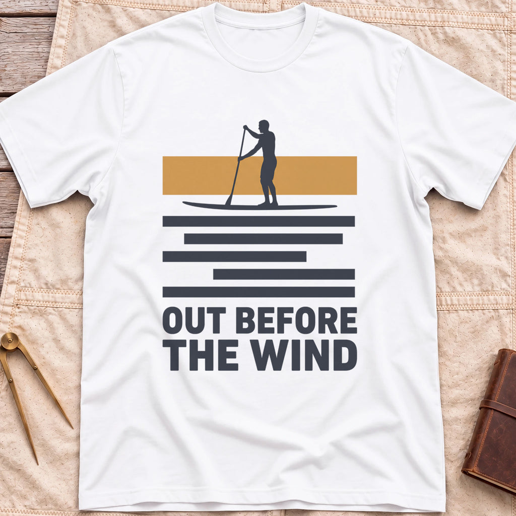 Front view of the white Out Before the Wind T-Shirt with a paddleboarder silhouetted against a tan band above striped water and the words Out Before the Wind.