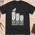Front view of the black Permanently Docked T-Shirt with a seagull perched on three wooden pilings.