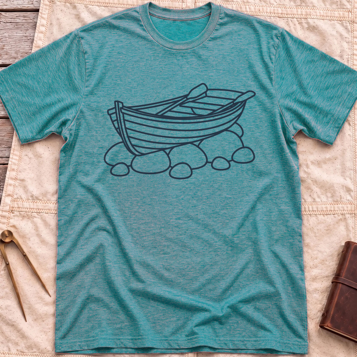 Front view of the heather galapagos blue Pulled Ashore T-Shirt with a line drawing of a rowing boat with oars, resting on rocks.