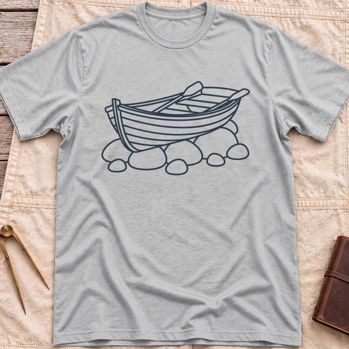 Front view of the sport grey Pulled Ashore T-Shirt with a line drawing of a rowing boat with oars, resting on rocks.