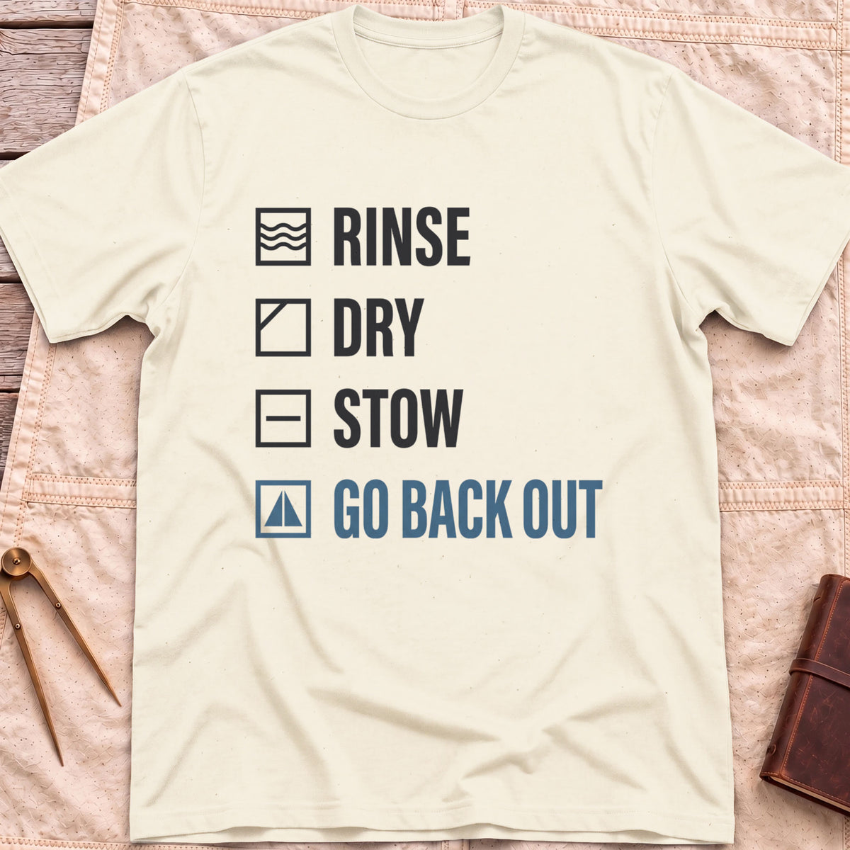 Front view of the natural Rinse Dry Stow T-Shirt with a checklist reading Rinse, Dry, Stow, Go Back Out, each beside a small icon.