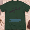 Front view of the forest green Rope Swing T-Shirt with a rope swing hanging from a leafy branch above water lines.