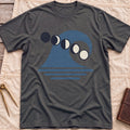 Front view of the dark heather Ruled by the Tides T-Shirt with a stylised wave, a row of moon phases and horizontal water lines.