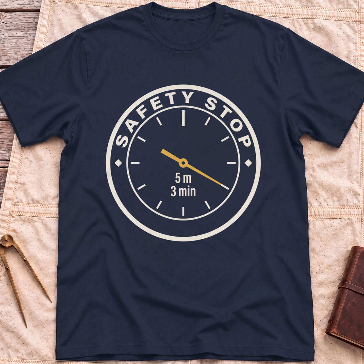 Front view of the navy Safety Stop T-Shirt with a round gauge reading Safety Stop around the edge and 5 m, 3 min at the centre.