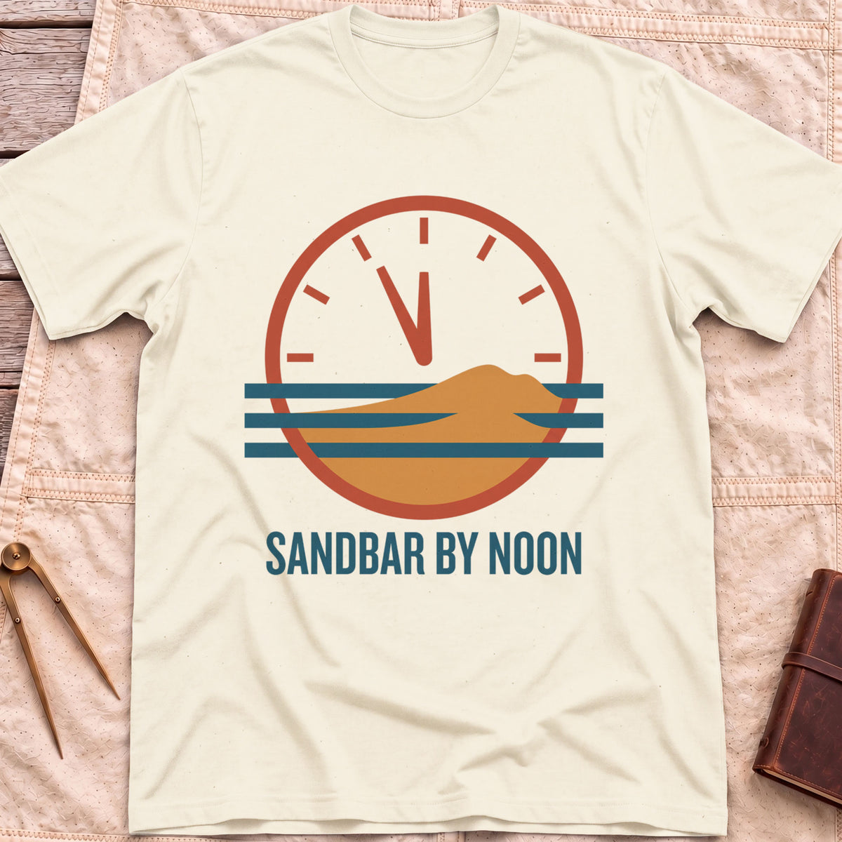 Front view of the natural Sandbar by Noon T-Shirt with a clock face set just before twelve above a sandbar and water lines.