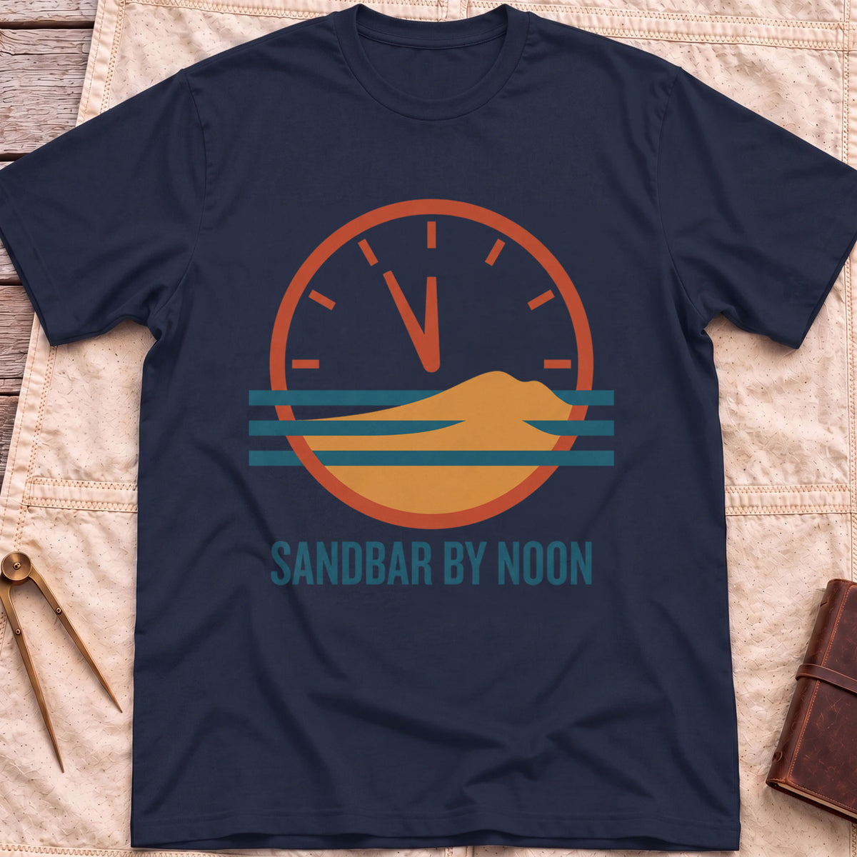 Front view of the navy Sandbar by Noon T-Shirt with a clock face set just before twelve above a sandbar and water lines.