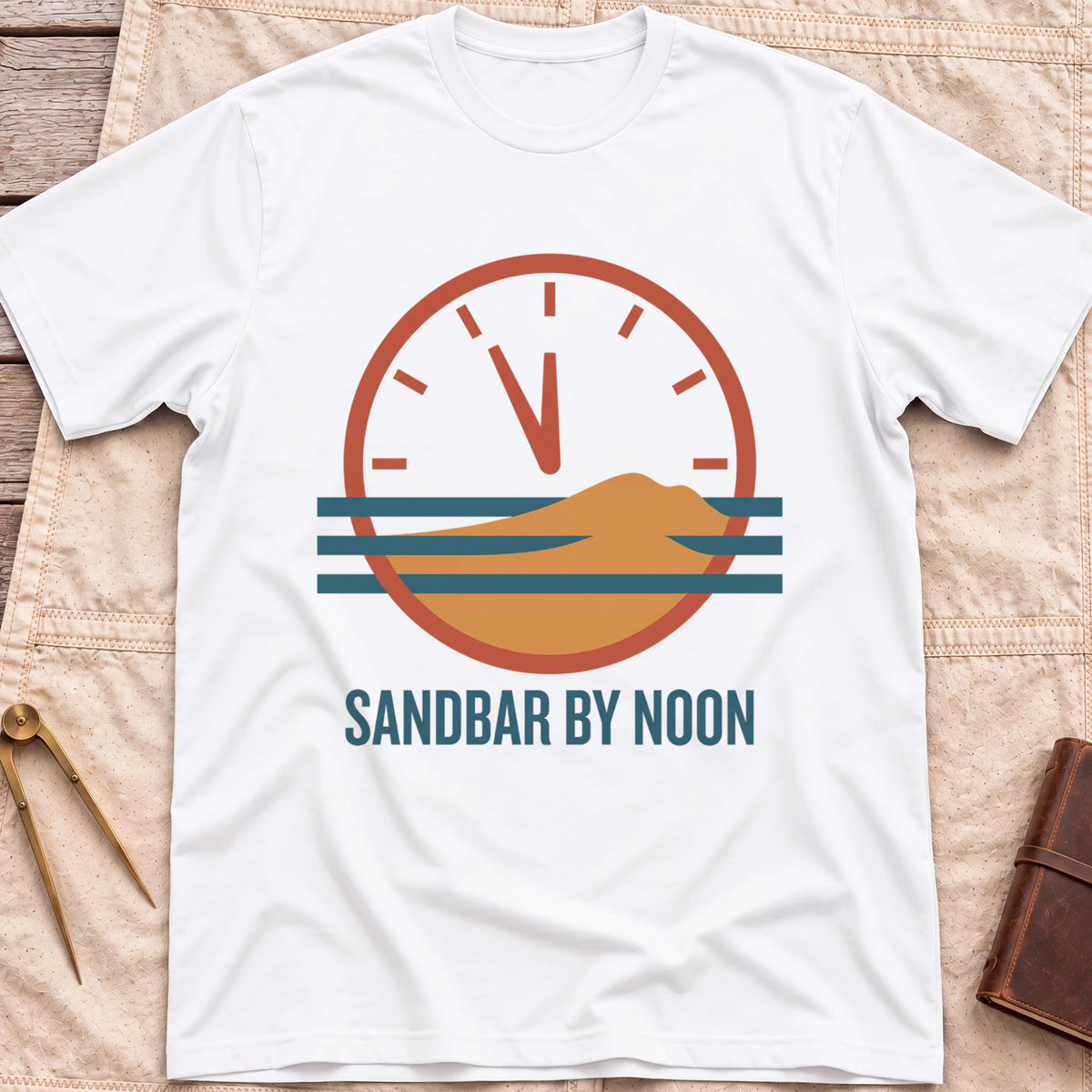 Front view of the white Sandbar by Noon T-Shirt with a clock face set just before twelve above a sandbar and water lines.