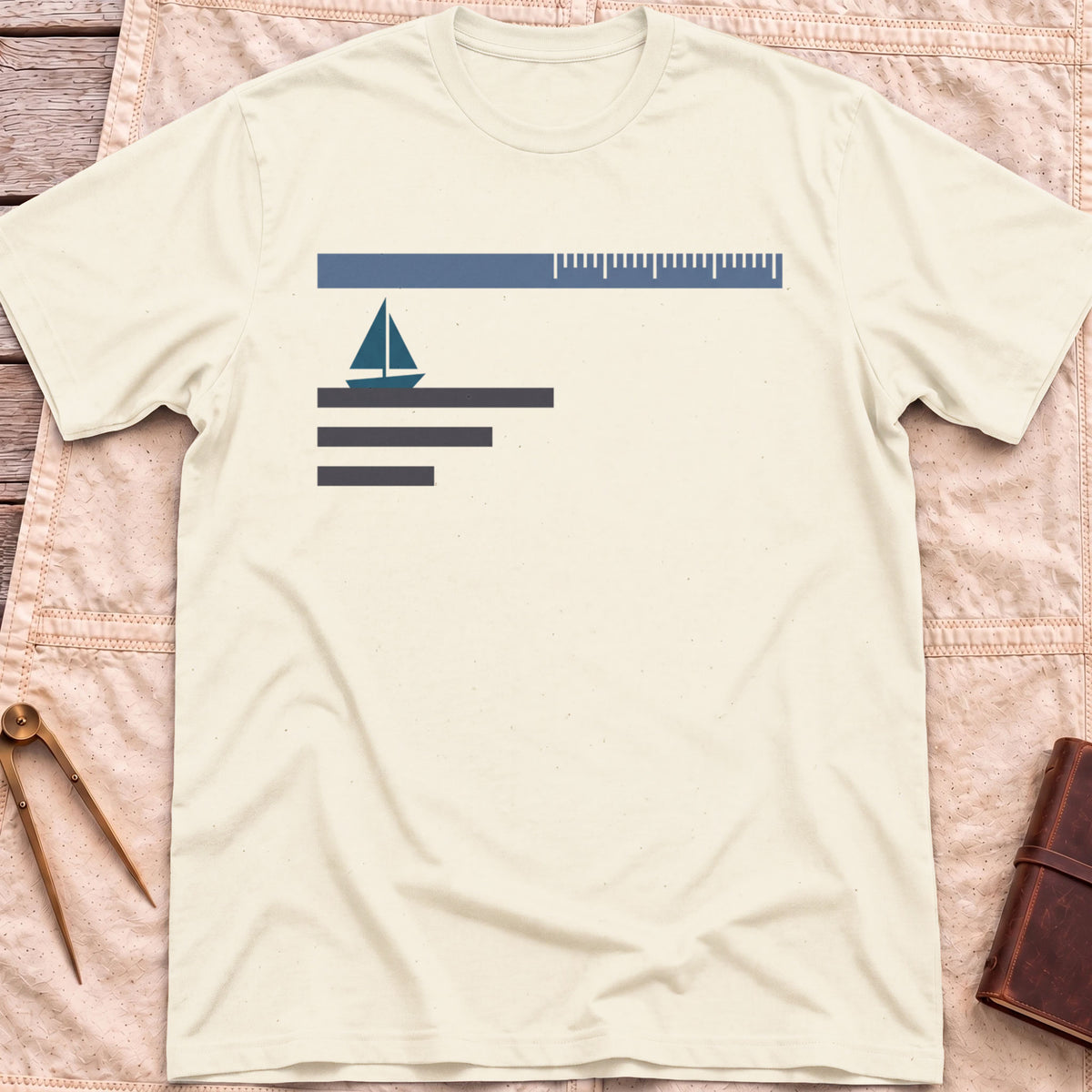 Front view of the natural Sea Room T-Shirt with a small sailboat beneath a long scale bar, above three stacked lines.