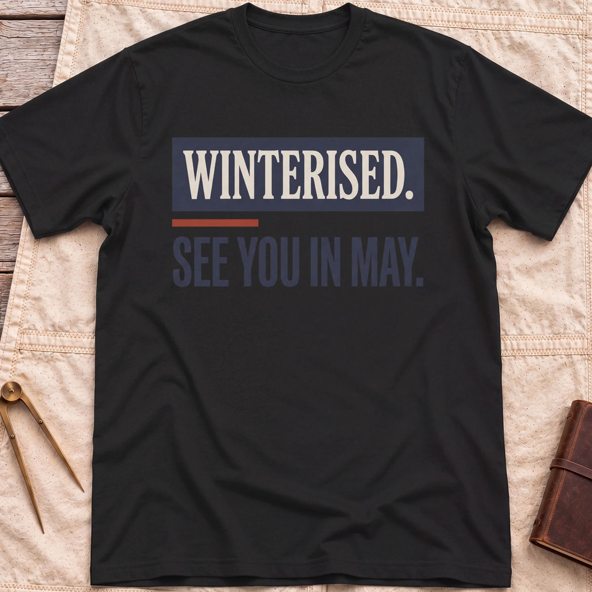 Front view of the black See You in May T-Shirt with the words Winterised. See You in May. in bold condensed type.