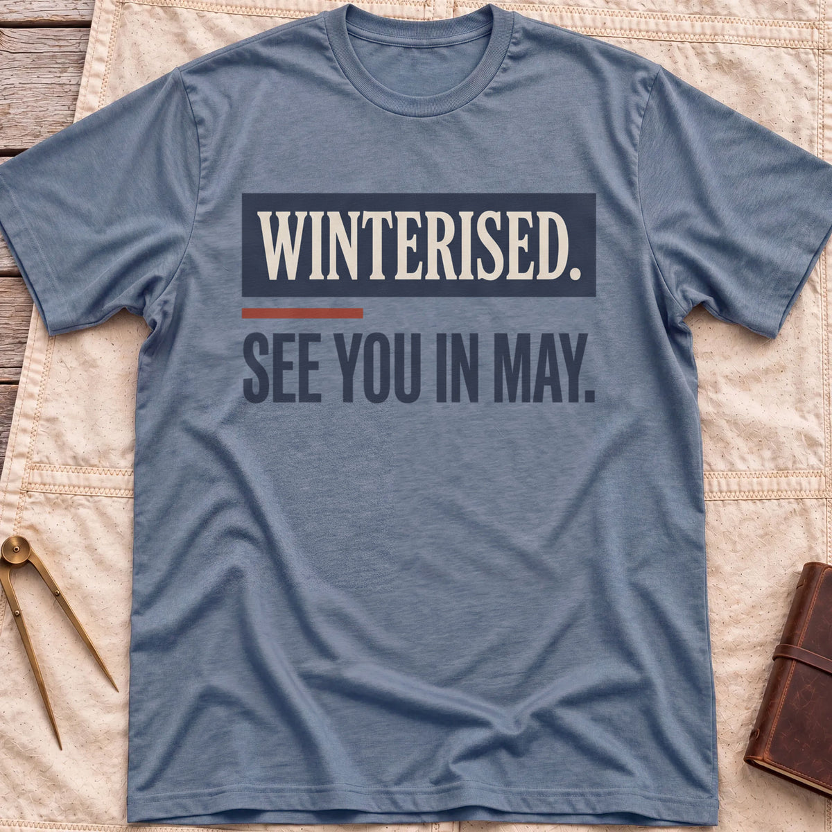 Front view of the heather indigo See You in May T-Shirt with the words Winterised. See You in May. in bold condensed type.