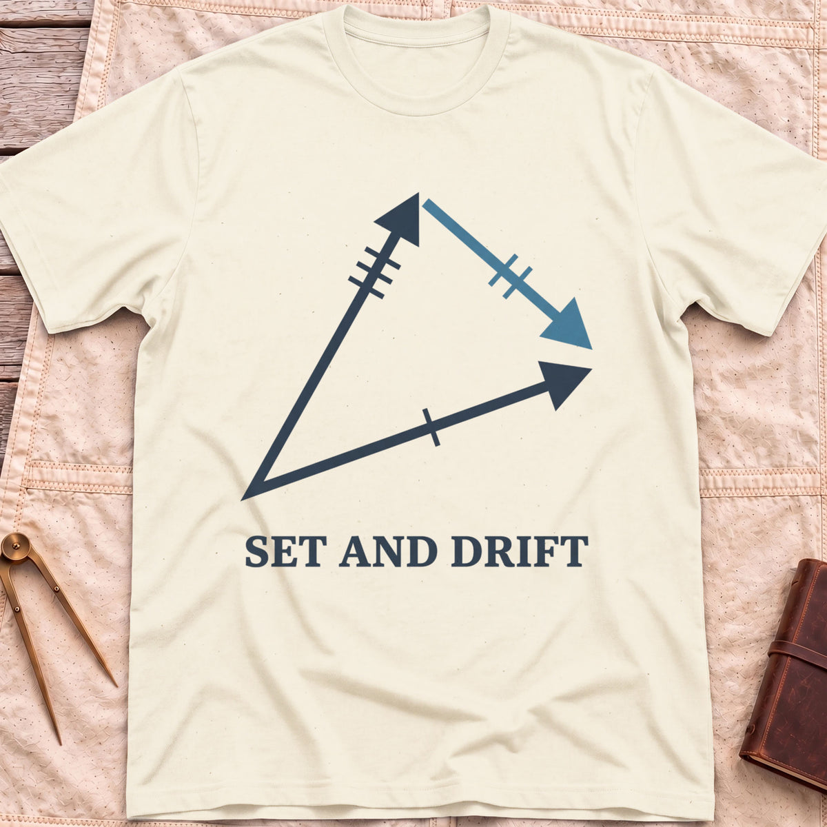 Front view of the natural Set and Drift T-Shirt with a triangle of three arrows marked with tick lines above the words Set and Drift.