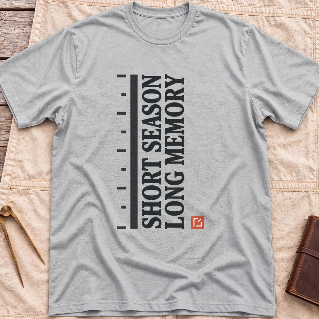 Front view of the sport grey Short Season Long Memory T-Shirt with the words Short Season Long Memory running vertically beside a tick-marked scale and a small red square.