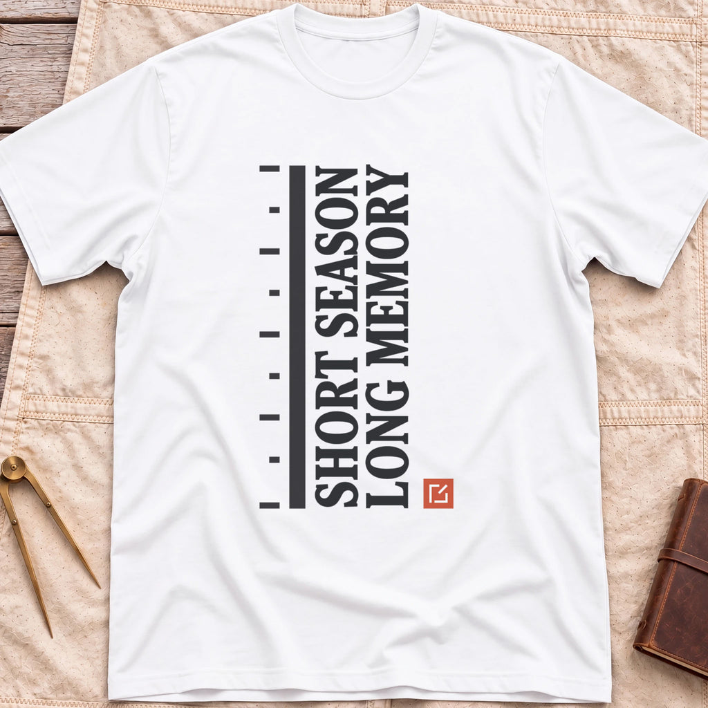 Front view of the white Short Season Long Memory T-Shirt with the words Short Season Long Memory running vertically beside a tick-marked scale and a small red square.