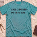 Front view of the heather galapagos blue Single Handed T-Shirt with the words Single-Handed and In No Hurry in serif capitals.