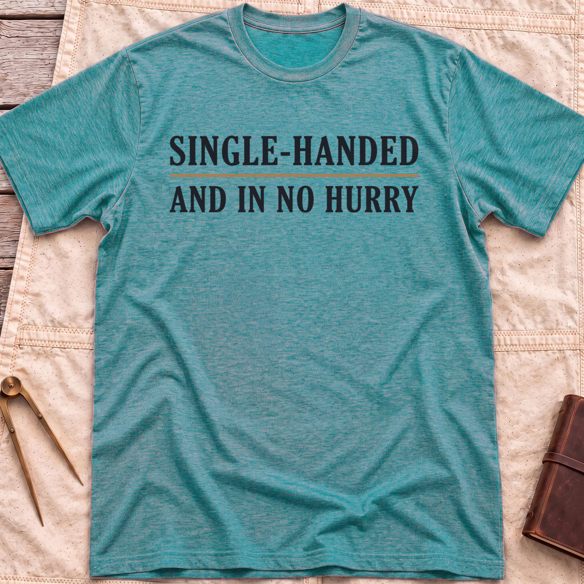 Front view of the heather galapagos blue Single Handed T-Shirt with the words Single-Handed and In No Hurry in serif capitals.
