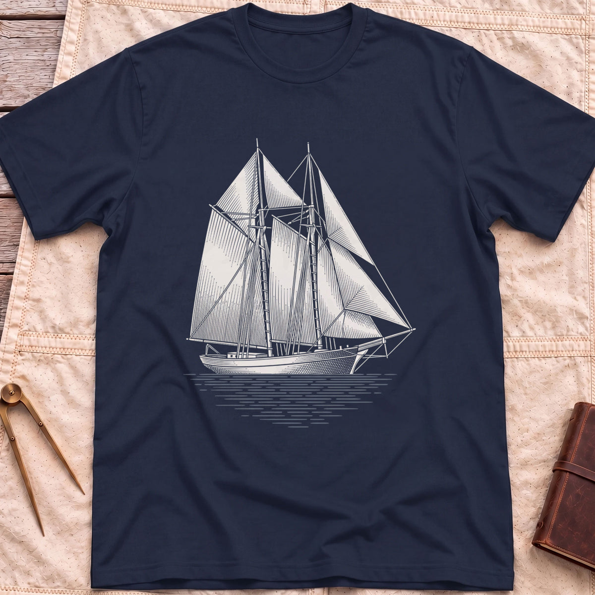 Front view of the navy Snug Harbour T-Shirt with a detailed white illustration of a two-masted sailing ship on the water.